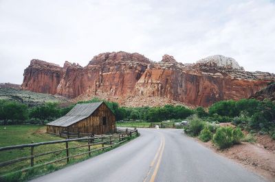 barn before red rock cliffs