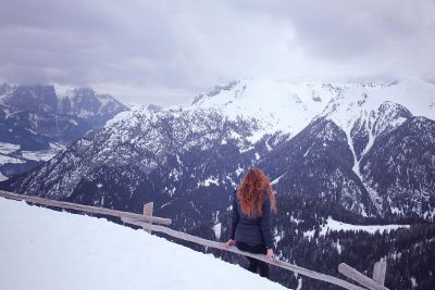 girl watching hills covered with ice