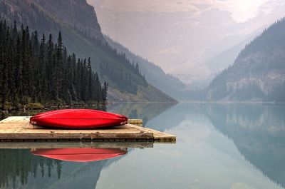 red canoe on peaceful lake