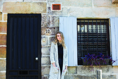 woman in front of brick building