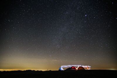 stars at night above a camp