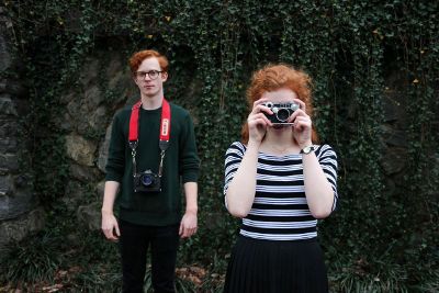 two people with cameras