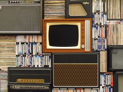 vintage shelf arrangement with tv and books and tapes