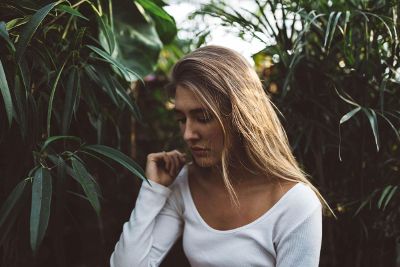 sad woman in vegetation