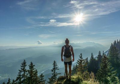 person standing on a mountain summit