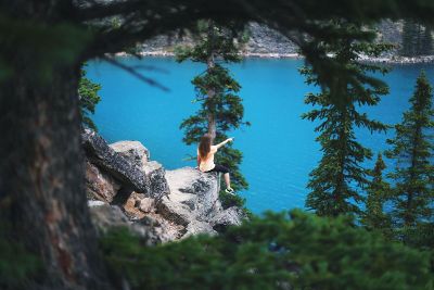 person on a cliff outdoors pointing