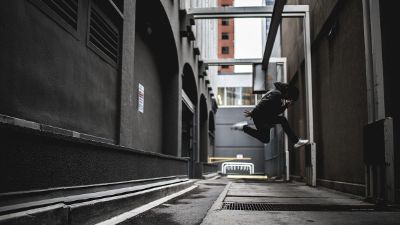 boy jumping in alley