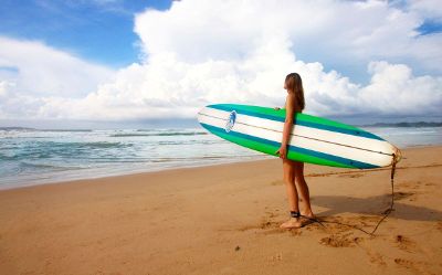 girl heading out to surf