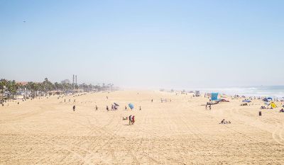 beach with people running and relaxing