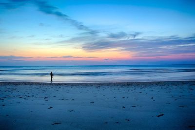 man on a beach fishing