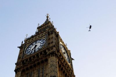 helicopter flying over clock tower