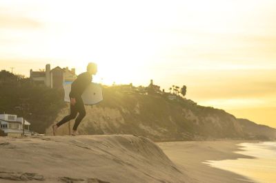 surfer running to water