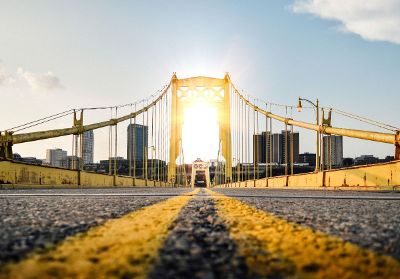 on a bridge facing sun