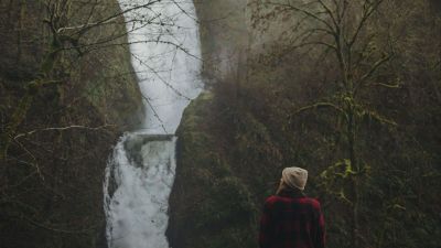 woman hiking to waterfall