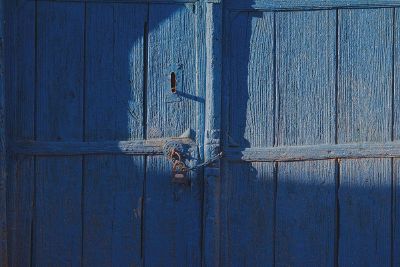 locked wooden gate painted blue