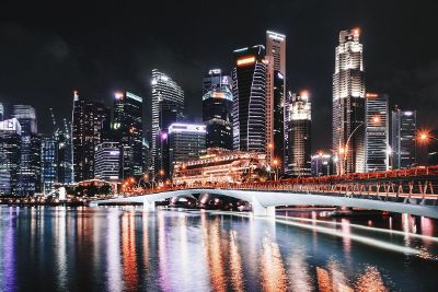 city at night with lit bridge