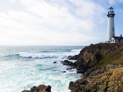 white lighthouse on cliff