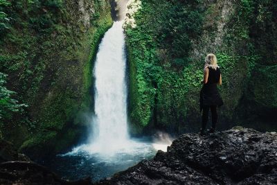 a woman in a waterfall