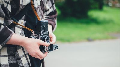 flannel shirted person with camera