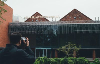 man photographing building