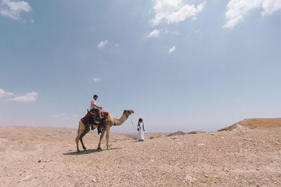 man on camel in desert