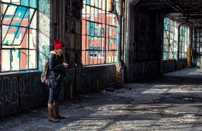 woman taking pictures in abandoned building
