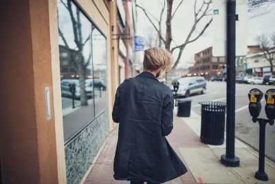 blonde male walking city streets