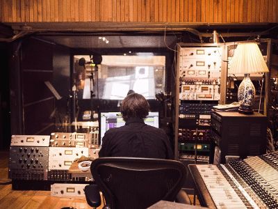 man sitting in sound studio