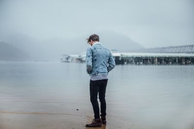 man standing at water