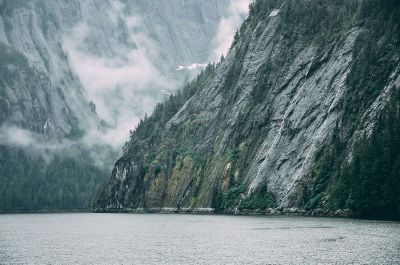 cloud peeking through mountain lake