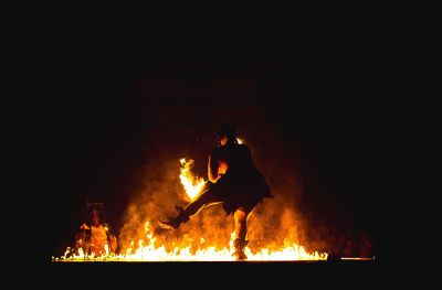man dancing near the fire