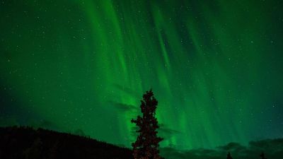 green sky with stars and mountain tops