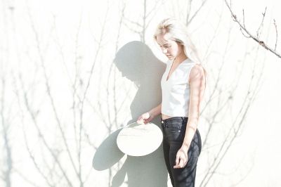 woman looking into mirror outside