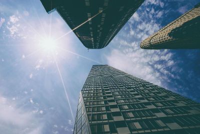 skyscrapers against clouds in sky