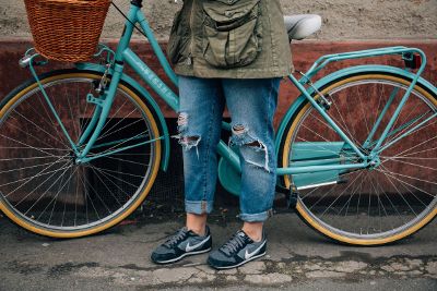 woman ripped jeans with bike