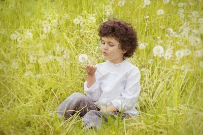 girl blowing dandelion