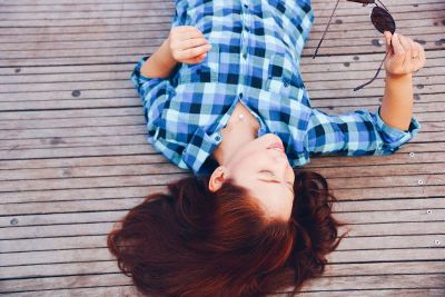 girl lying on a deck