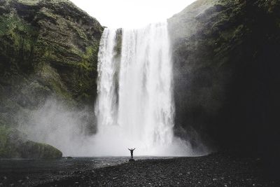 joyful person at waterfall