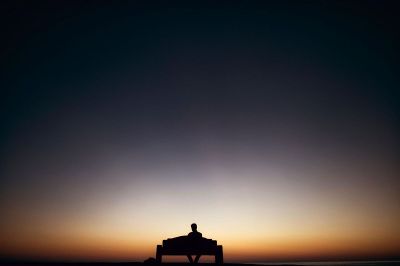 silhouette of person on bench