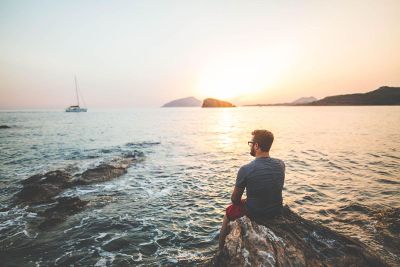 man sitting by a cove