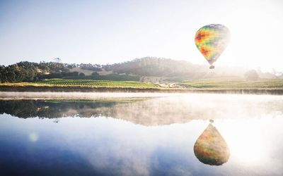 hot air balloon flying over water