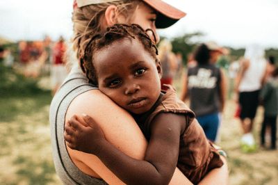 humanitarian holding small child