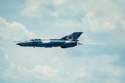 jet plane flying in blue cloudy sky