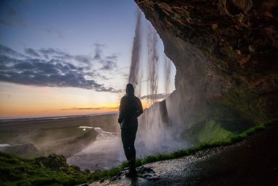 person under waterfall