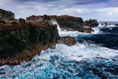 an ocean meeting rocky land