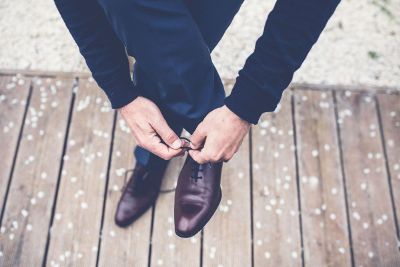 man tying shoe