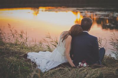 couple sitting by lake