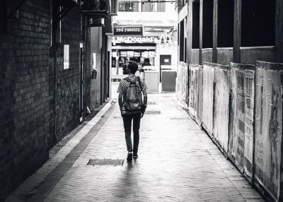 man walking in an alley
