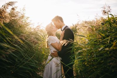 couple kissing in field