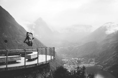 man jumping near edge of balcony